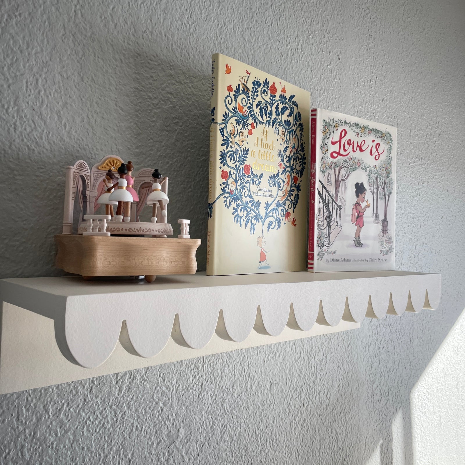 scalloped shelf with books and music box