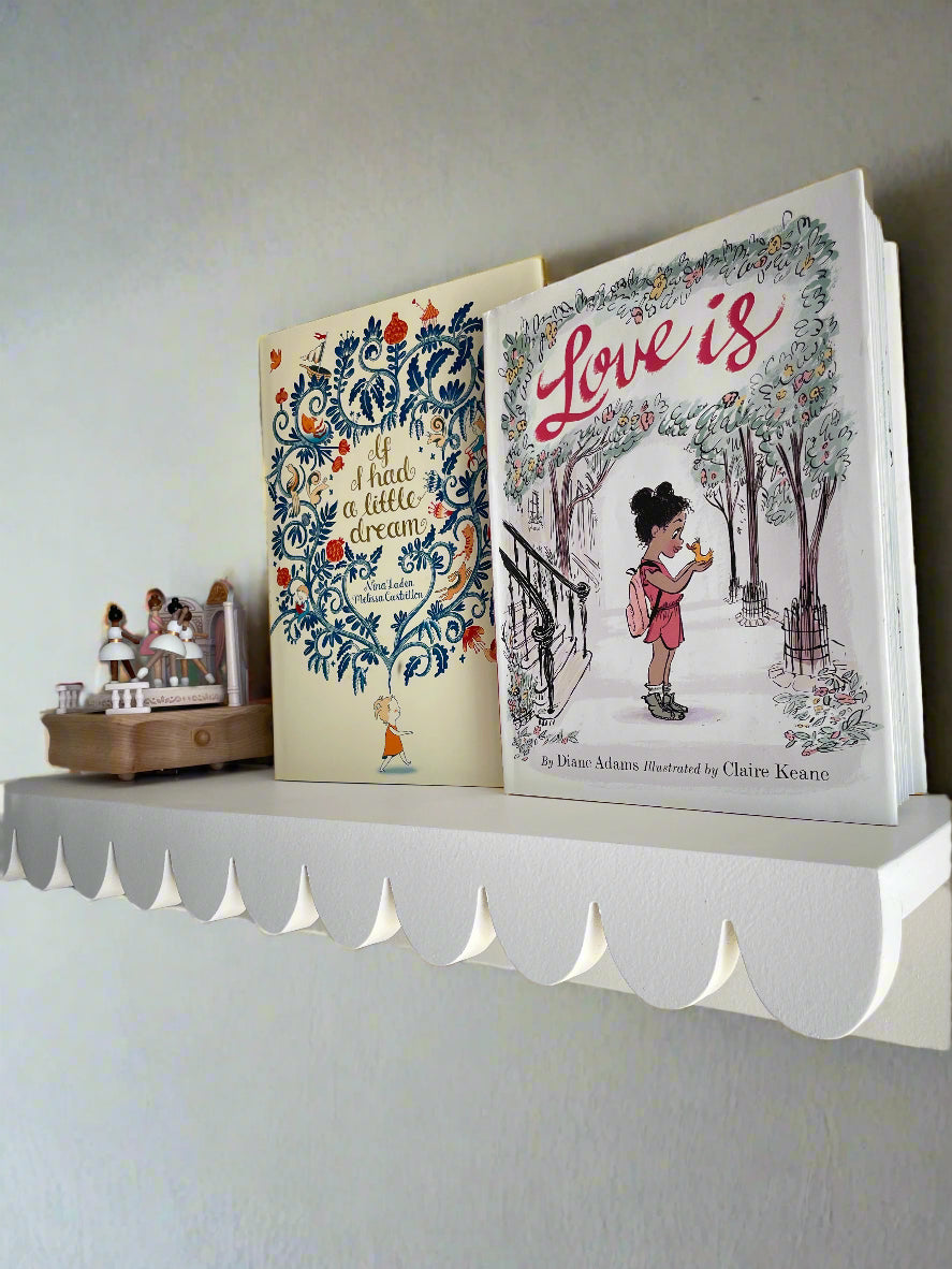 scalloped shelf with books and music box