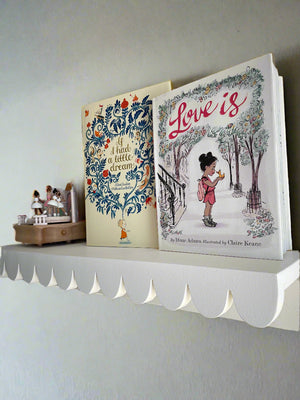 scalloped shelf with books and music box